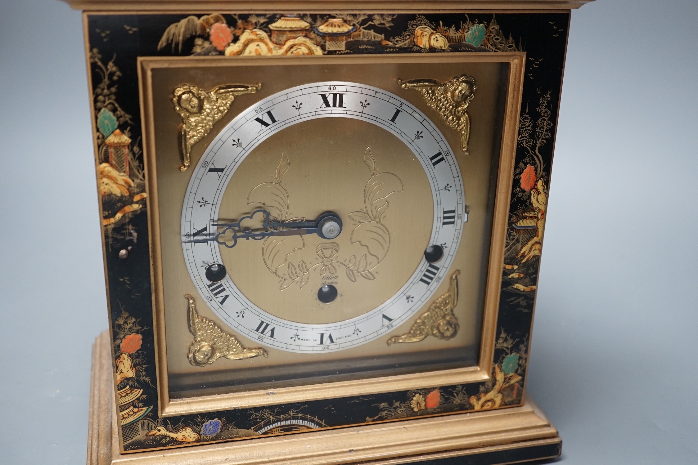 A F.W. Elliott japanned mantel clock, with chiming mechanism, 32 cms high